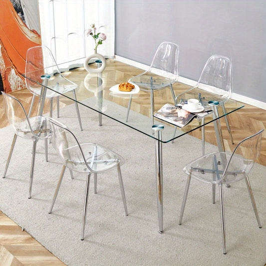 Table and chair set.Modern rectangular glass dining table with tempered glass countertop and silver metal legs, paired with multiple transparent high-quality PET dining chairs with silver legs.