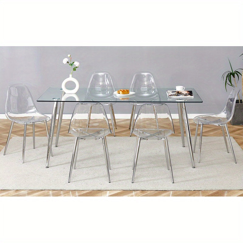 Table and chair set.Modern rectangular glass dining table with tempered glass countertop and silver metal legs, paired with multiple transparent high-quality PET dining chairs with silver legs.
